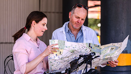 Cyclists using active travel maps to plan their journey.