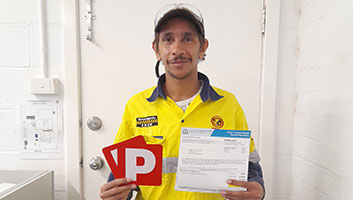 Jesse holding his P plates after getting his driver's licence.