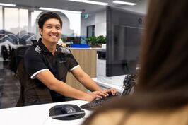 A DoT customer service officer attends to a customer at a DVS centre.