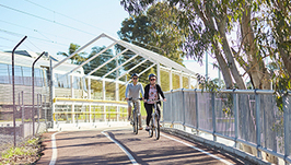 Two bike riders riding along a shared path