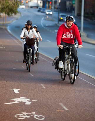 Two cyclists cycling along a shared path