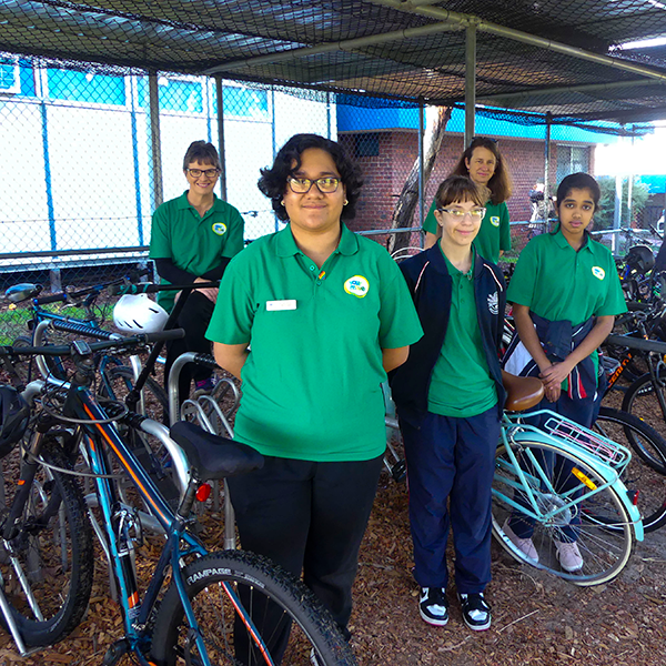 The TSHS Your Move team smiling while standing with new bike racks