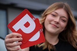 Red P-plates being held by a novice driver