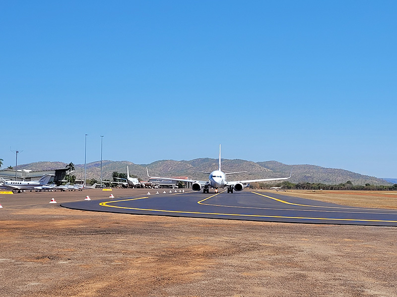 A plane taxis down a runway at Kununurra Airport